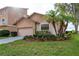 Well-maintained exterior with lush landscaping and palm trees, complemented by the charming home design at 6340 Garland Ct, New Port Richey, FL 34652
