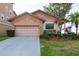 Charming home featuring well-maintained landscaping, a two-car garage, and stone accents at 6340 Garland Ct, New Port Richey, FL 34652