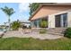 Home exterior featuring a waterfront patio with stone grill and a sunroom at 6340 Garland Ct, New Port Richey, FL 34652