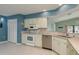 Kitchen features white cabinetry, stainless steel appliances, tile backsplash, and lots of natural light at 6340 Garland Ct, New Port Richey, FL 34652