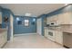 Bright eat-in kitchen featuring white cabinetry, stainless steel appliances, tile flooring, and a skylight at 6340 Garland Ct, New Port Richey, FL 34652