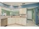 Kitchen features stainless steel dishwasher, tiled backsplash, and views to living room at 6340 Garland Ct, New Port Richey, FL 34652