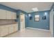 Bright laundry room features tile floors, a skylight, washer, and white cabinets at 6340 Garland Ct, New Port Richey, FL 34652