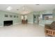 Open-concept living area featuring tile floors, ceiling fan, dining area, and natural light from the skylight at 6340 Garland Ct, New Port Richey, FL 34652