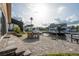 Paver patio features a built-in outdoor kitchen and leads to a screened lanai with a water view at 6340 Garland Ct, New Port Richey, FL 34652