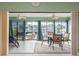 Inviting sunroom with tile floors, ceiling fans, and stunning waterfront views through expansive sliding glass doors at 6340 Garland Ct, New Port Richey, FL 34652