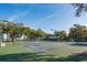 Community tennis courts surrounded by trees and neighborhood buildings at 6340 Garland Ct, New Port Richey, FL 34652