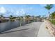 View of waterfront docks in a canal with boats in boat lifts and lush green landscaping at 6340 Garland Ct, New Port Richey, FL 34652