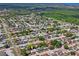 An aerial view showing the property nestled in a vibrant neighborhood, surrounded by lush greenery and other homes at 6442 Sutherland Ave, New Port Richey, FL 34653
