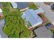 The aerial view shows the roof, patio, landscaping, and the car port area near the back of the house at 6442 Sutherland Ave, New Port Richey, FL 34653