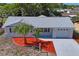 An aerial view showing the manicured lawn, new roof and proximity to neighborhood amenities at 6442 Sutherland Ave, New Port Richey, FL 34653