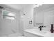 Modern bathroom featuring a sleek vanity, new fixtures, and a combined tub and shower at 6442 Sutherland Ave, New Port Richey, FL 34653