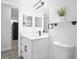 Bright bathroom featuring a white vanity with modern fixtures and a decorative mirror at 6442 Sutherland Ave, New Port Richey, FL 34653