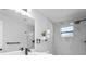 Sleek bathroom featuring a modern shower with marble tile and a floating vanity with dark fixtures at 6442 Sutherland Ave, New Port Richey, FL 34653