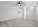 Spacious bedroom with neutral colors, a ceiling fan, and closet with double doors at 6442 Sutherland Ave, New Port Richey, FL 34653