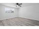 Well-lit, spacious bedroom featuring neutral colors and wood-look flooring at 6442 Sutherland Ave, New Port Richey, FL 34653