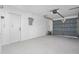 The spacious garage is equipped with an automatic door and ample room for storage and parking at 6442 Sutherland Ave, New Port Richey, FL 34653