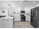 Bright kitchen showcasing modern appliances, sleek countertops, and open floor plan at 6442 Sutherland Ave, New Port Richey, FL 34653