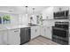 Updated kitchen features stainless steel appliances, sleek countertops, and modern cabinetry at 6442 Sutherland Ave, New Port Richey, FL 34653
