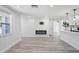 Inviting living room boasts an electric fireplace and is open to the modern kitchen at 6442 Sutherland Ave, New Port Richey, FL 34653