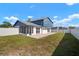 Spacious fenced backyard with a screen enclosed porch and concrete patio is great for outdoor enjoyment at 6841 Mitchell Cir, Tampa, FL 33634