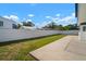 Backyard featuring a concrete patio and green grass with a white privacy fence at 6841 Mitchell Cir, Tampa, FL 33634