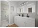 Bright bathroom features a dual sink vanity, white cabinets and brushed black fixtures at 6841 Mitchell Cir, Tampa, FL 33634
