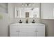 Bright bathroom features a dual sink vanity, white cabinets and brushed black fixtures at 6841 Mitchell Cir, Tampa, FL 33634