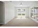Neutral bedroom with carpeted floors, natural light, and sliding glass doors to the exterior at 6841 Mitchell Cir, Tampa, FL 33634