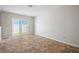 Bright bedroom with tile flooring, sliding glass door to the yard providing abundant natural light at 6841 Mitchell Cir, Tampa, FL 33634