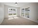 Bright bedroom showcasing natural light through expansive windows overlooking the home's yard at 6841 Mitchell Cir, Tampa, FL 33634