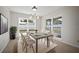 Bright dining room with modern furnishings, natural light, and views of the exterior yard at 6841 Mitchell Cir, Tampa, FL 33634