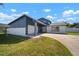 Two-story home featuring an attached two car garage, double door entry and a spacious front yard at 6841 Mitchell Cir, Tampa, FL 33634