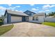 Two-story home featuring an attached two car garage, double door entry and a spacious concrete driveway at 6841 Mitchell Cir, Tampa, FL 33634
