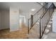 Welcoming foyer with tile flooring, staircase with black railing, and easy access to other rooms at 6841 Mitchell Cir, Tampa, FL 33634