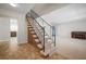 Foyer with tile flooring, staircase with metal railing, and convenient access to living spaces at 6841 Mitchell Cir, Tampa, FL 33634