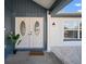 Close up of front door with sidelight window and bird of paradise planter at 6841 Mitchell Cir, Tampa, FL 33634
