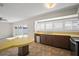 Bright kitchen space with a table and breakfast bar, featuring white shutters and sliding glass doors to the exterior at 6841 Mitchell Cir, Tampa, FL 33634