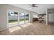 Open concept kitchen with tile flooring and sliding glass doors to backyard at 6841 Mitchell Cir, Tampa, FL 33634