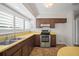 Kitchen featuring wood cabinetry, stainless steel appliances, and laminate countertops at 6841 Mitchell Cir, Tampa, FL 33634