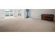 Open-concept living area with neutral carpeting, natural light, a piano, and access to the yard at 6841 Mitchell Cir, Tampa, FL 33634