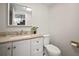 Well-lit powder room featuring a white vanity, granite countertop, and modern toilet at 6841 Mitchell Cir, Tampa, FL 33634