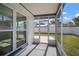 The screened porch provides views of the backyard and access to the outside at 6841 Mitchell Cir, Tampa, FL 33634