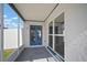The screened porch features blue french doors and large windows to enjoy the outdoors at 6841 Mitchell Cir, Tampa, FL 33634