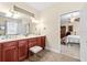 Spacious bathroom with double sinks, a cherry vanity, and access to the bedroom, for a comfortable experience at 6934 Duffy Ln, Tampa, FL 33616