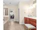 Bright bathroom featuring a double vanity, soaking tub, and a separate shower stall, with walk-in closet access at 6934 Duffy Ln, Tampa, FL 33616
