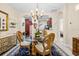 Elegant dining room with a chandelier, glass table, and ornate chairs near the kitchen at 6934 Duffy Ln, Tampa, FL 33616
