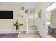 Inviting entryway with staircase, tile flooring, and natural light at 6934 Duffy Ln, Tampa, FL 33616