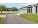 Home exterior featuring an attached two-car garage and landscaping at 6934 Duffy Ln, Tampa, FL 33616