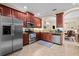 Spacious kitchen featuring stainless steel appliances and dark wood cabinetry at 6934 Duffy Ln, Tampa, FL 33616